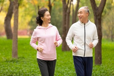 senior chinese couple jogging in the park